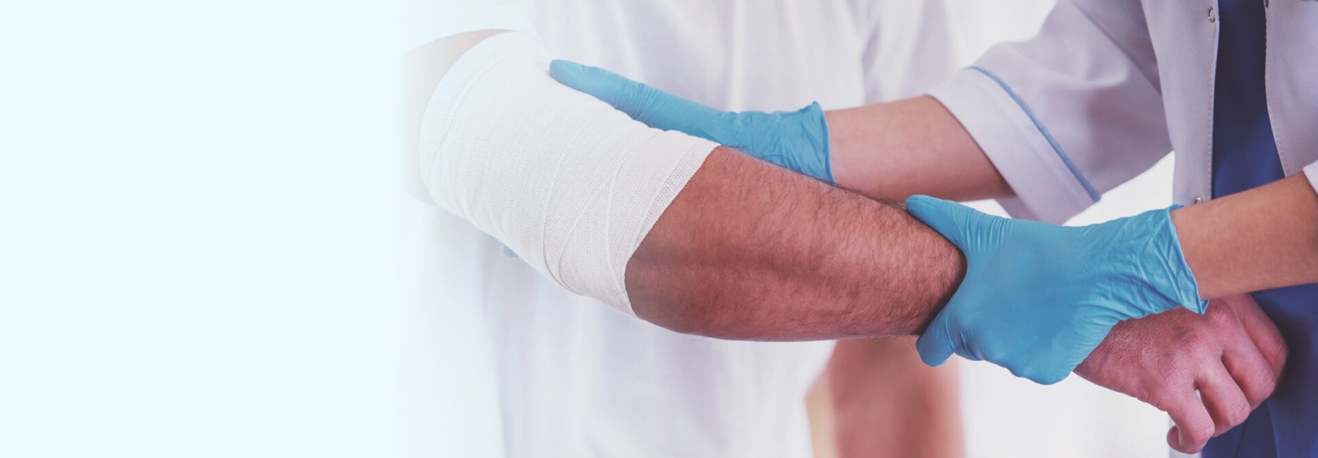 A Ortho surgeon bandages a patient's arm during elbow replacement treatment at Sri Balaji Hospital in Chennai.